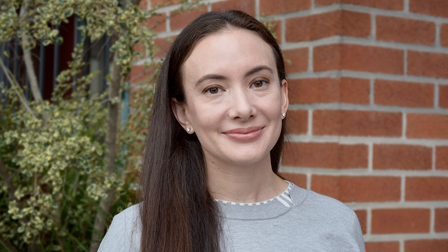 Leanna Reyes — woman with long dark hair, gray sweater