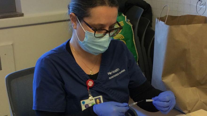 Nurse looks at COVID-19 vaccination