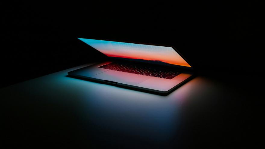 Laptop half open with dark background