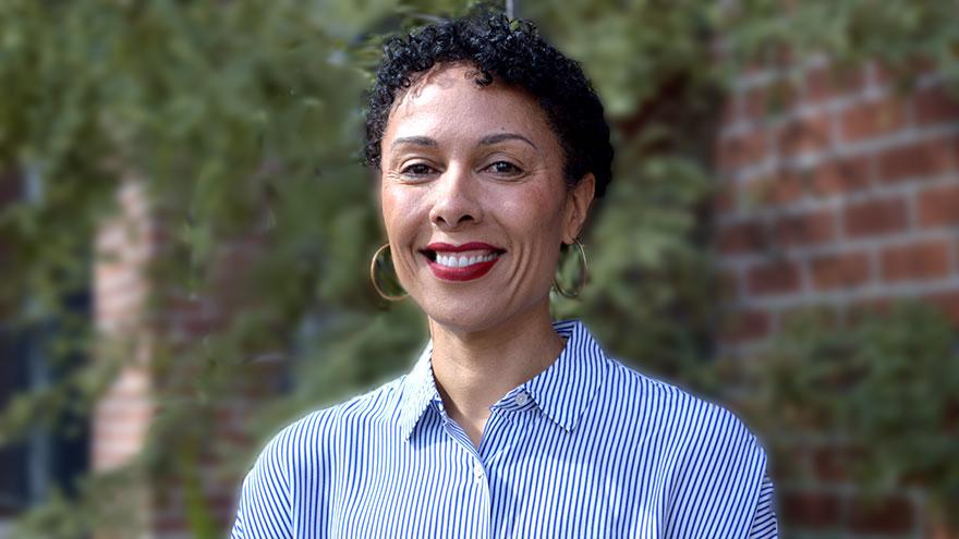 Madrone Love: woman with short dark curly hair wearing blue shirt