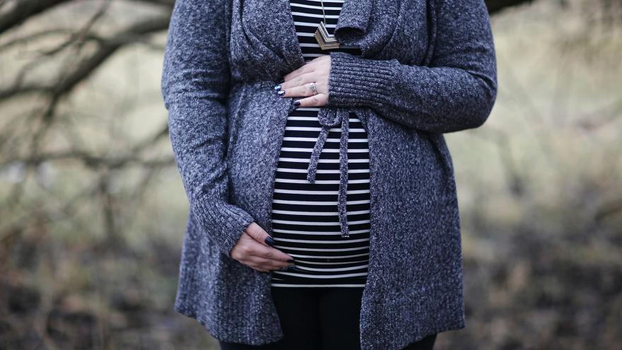 pregnant woman holding belly