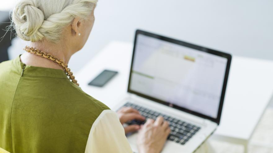 back of the head of a woman working on computer
