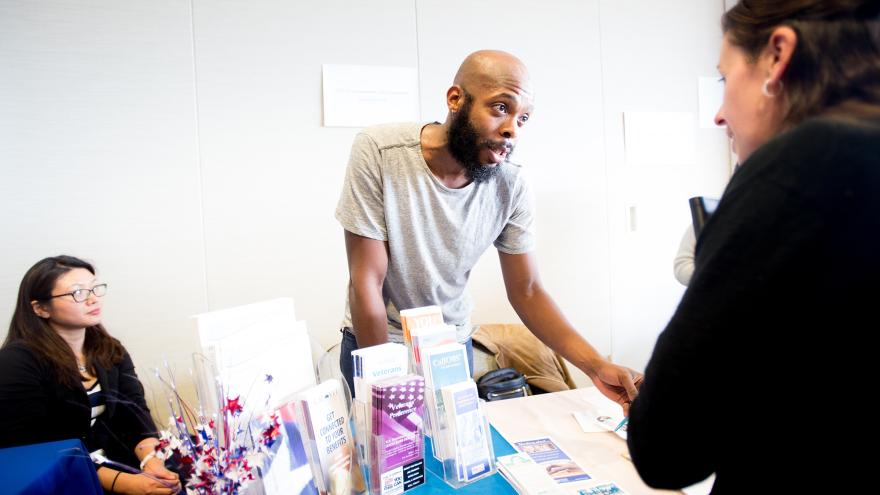 UCSF employee shares information with an attendee of the Veterans Job Fair