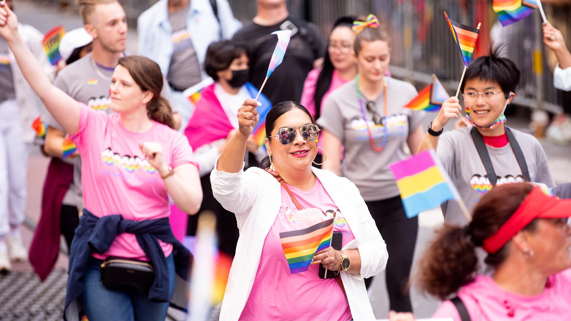 UCSF employees wave pride flags while marching in SF Pride march