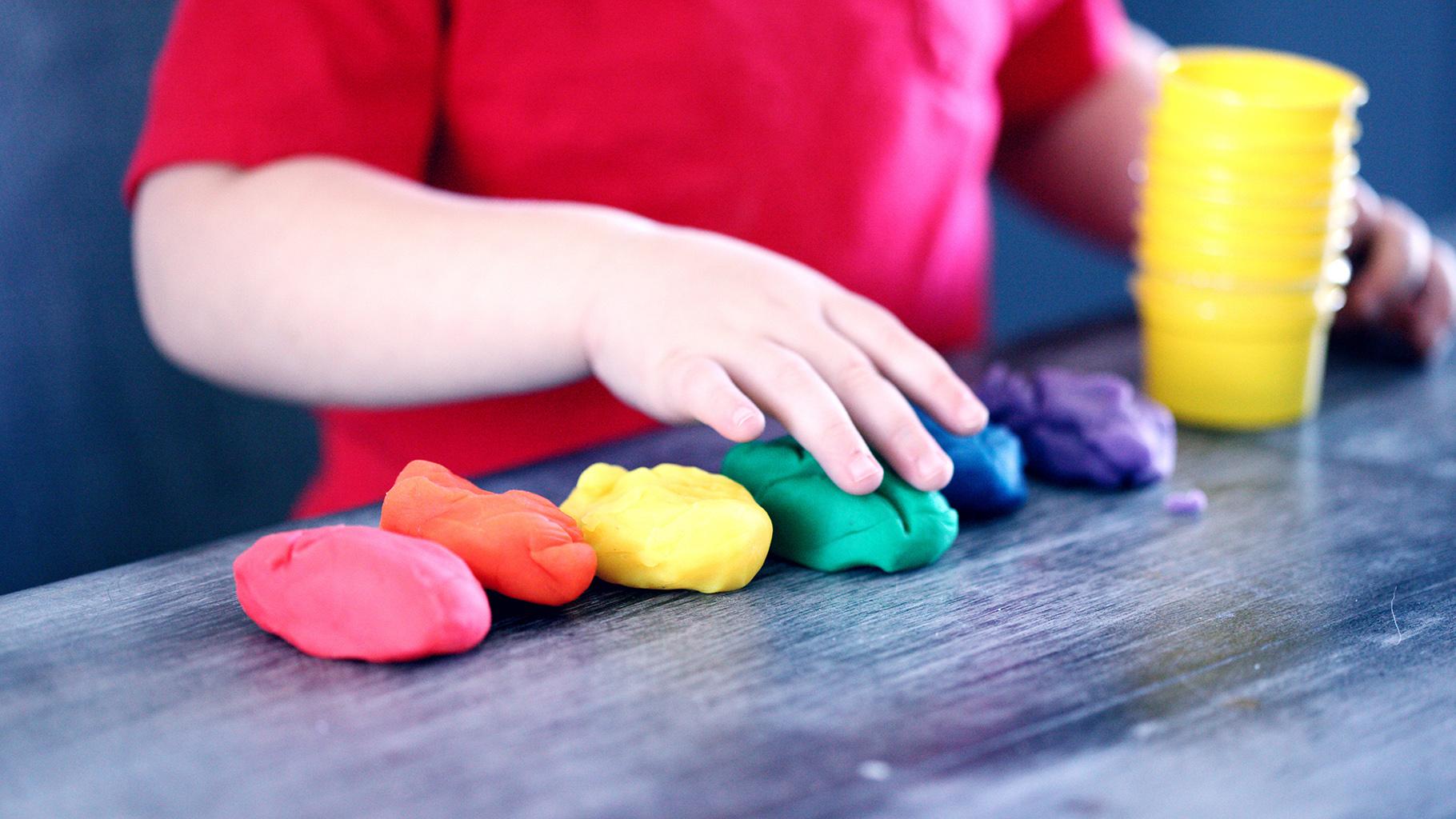 child plays with playdough