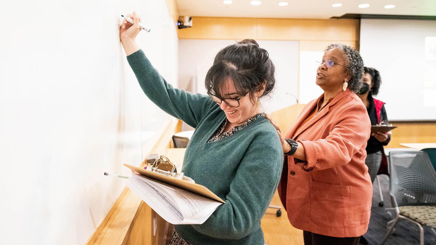 Postdoc writes on board