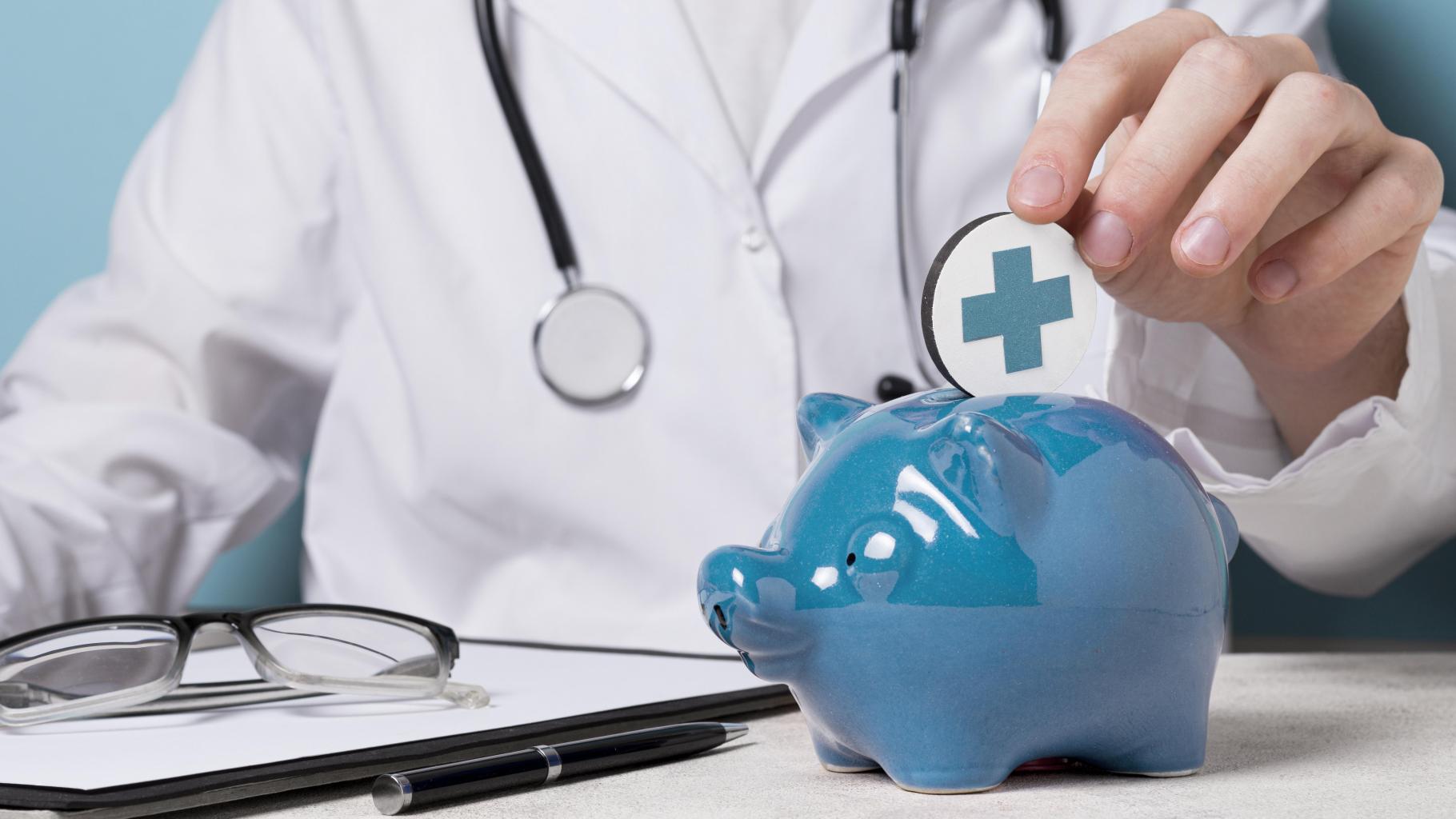 Doctor putting a coin in a blue piggy bank
