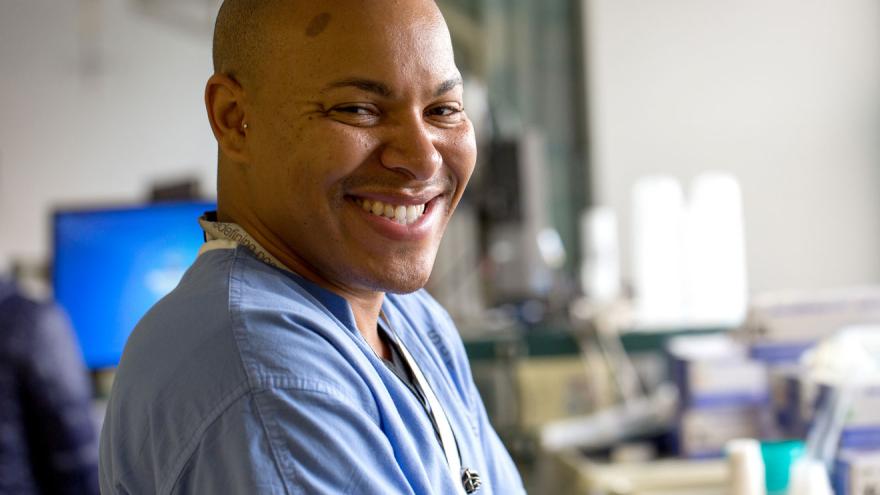 smiling man in scrubs